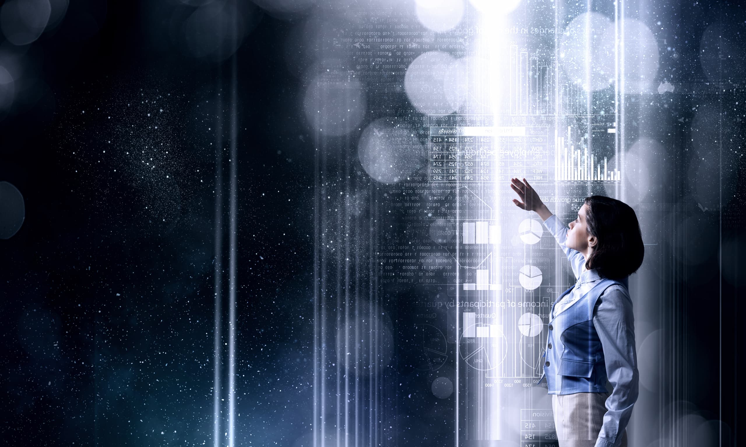 A person interacting with a glowing digital interface displaying charts and data code as part of an enterprise digital transformation.
